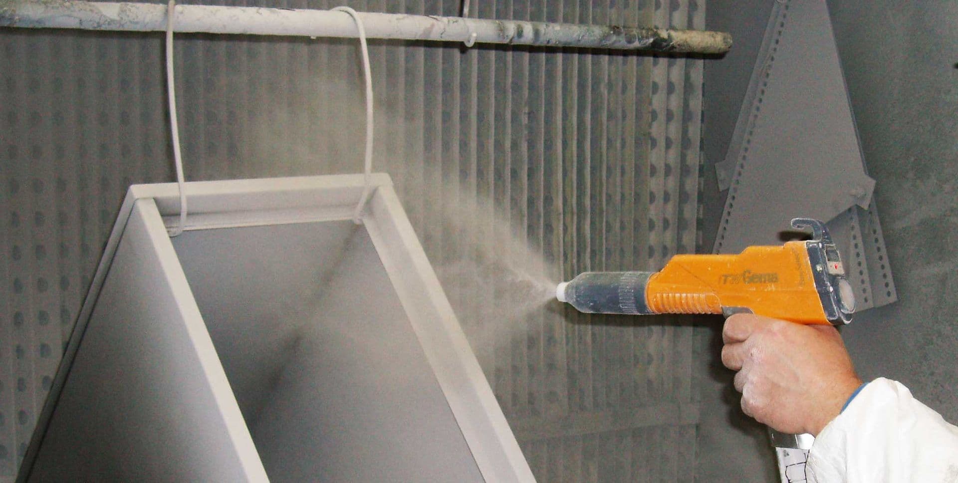 Electrostatic powder coating spray gun applying finish to a part